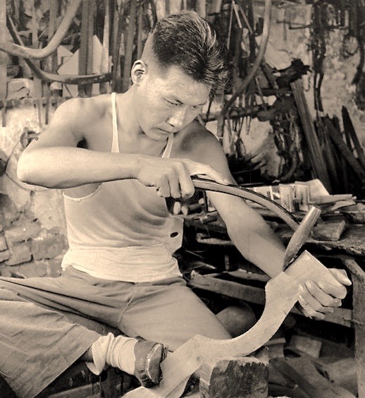 A man constructing a stock for an Chinese pellet crossbow. Photo by Hedda Morrison at Ju Yuan Hao, Beijing, 1935.