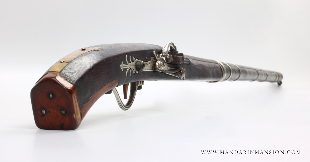 A rare 18th century Vietnamese matchlock musket with ivory butt plates and all-silver lock and mountings.